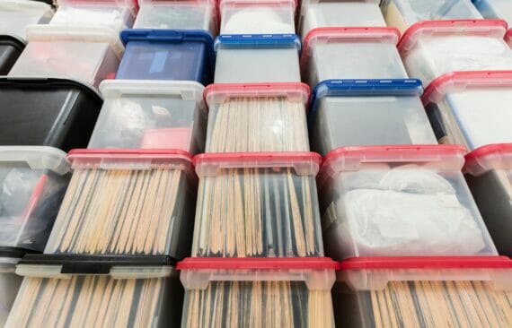 A stack of see-through plastic storage totes