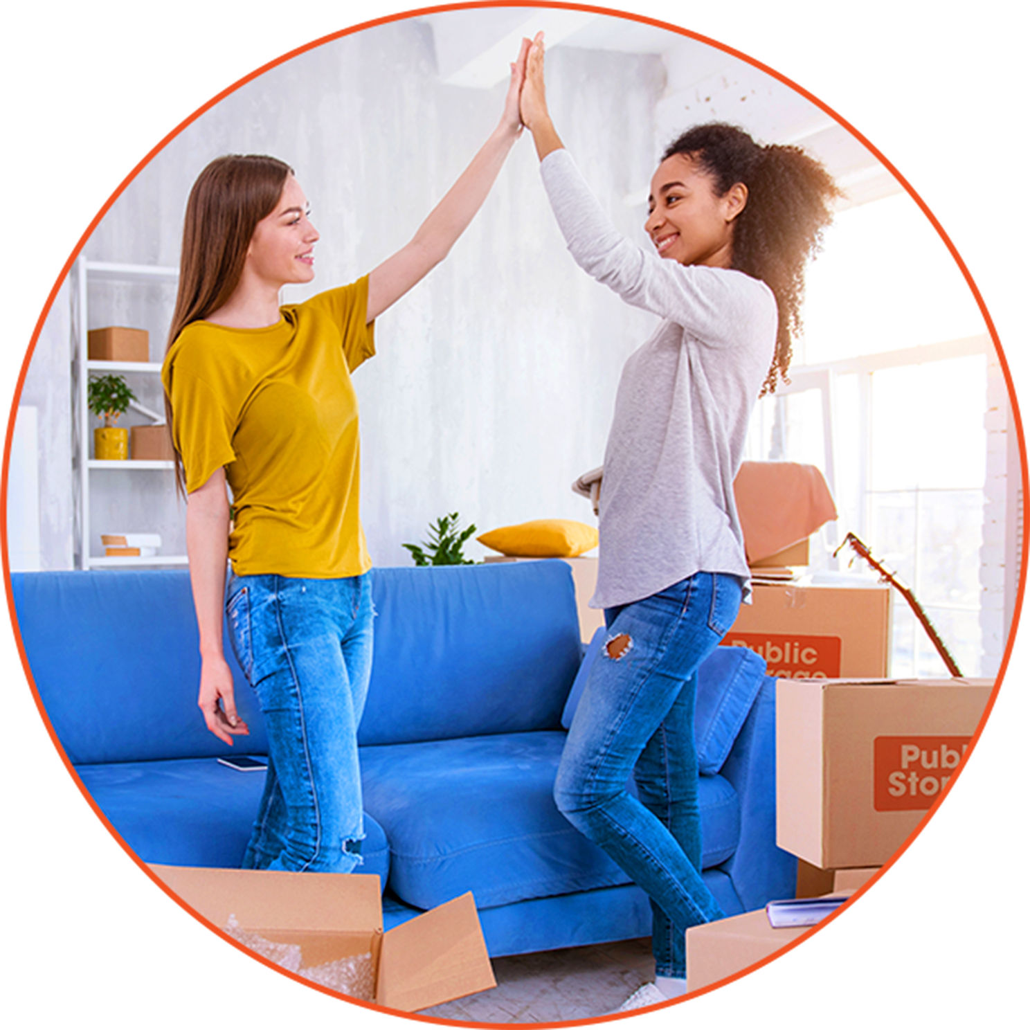 Two young women standing in a living room doing a high-five